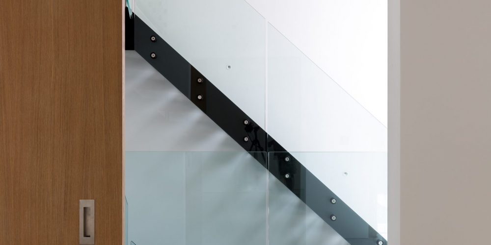 Simple domestic modern staircase viewed through a sliding door.