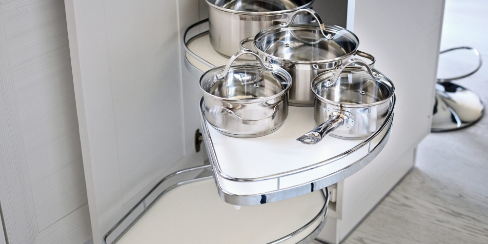 Solution for a kitchen corner storage in cupboard. Corner unit with pullout shelves for cookware